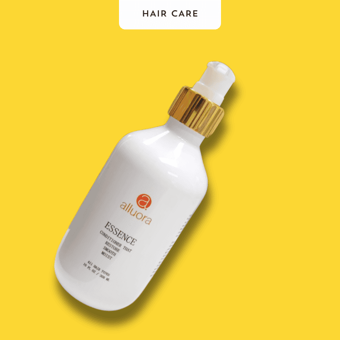 Silky hair conditioner bottle with gold cap, Alluora Essence Hair Care product on bright yellow background.