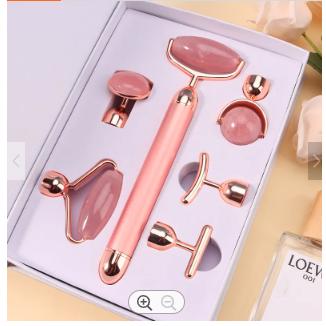 Rose gold facial roller set with multiple attachments for skincare and facial massage.