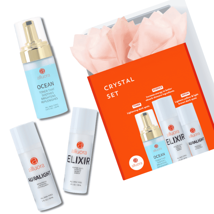 Brightening skin care set with Alluora Ocean toner, Elixir serum, and AuraLight moisturizer.