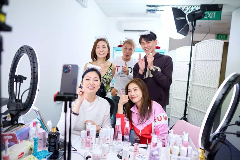 Bright women showcasing skincare products in a beauty studio.