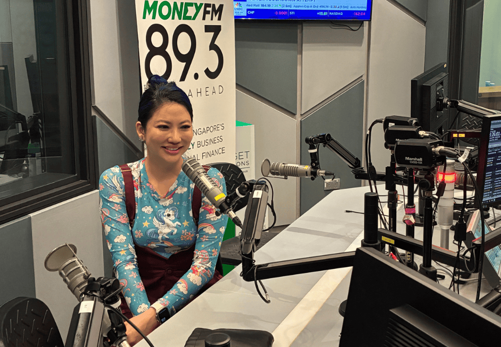 Female radio host speaking into microphone during broadcasting session at Alluora studio.Skincare brands