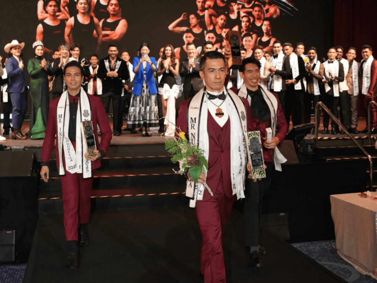 Alluora event featuring Mr. Indonesia 2023 contestants on stage, with vibrant traditional and formal attire.