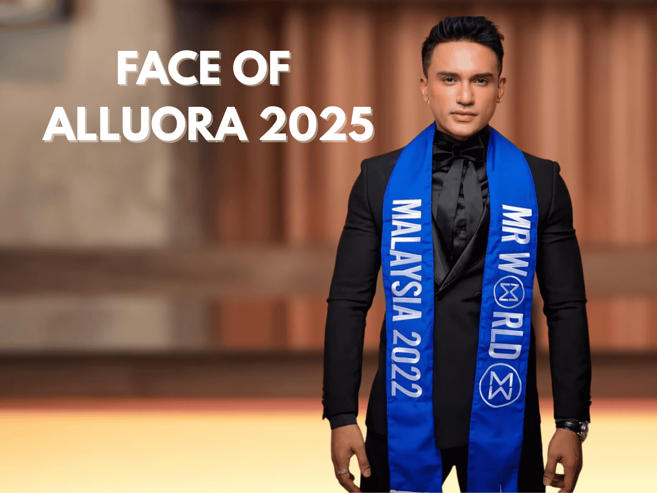 Elegant man wearing a sash, candidate for Mr. World 2025, at a pageant event.